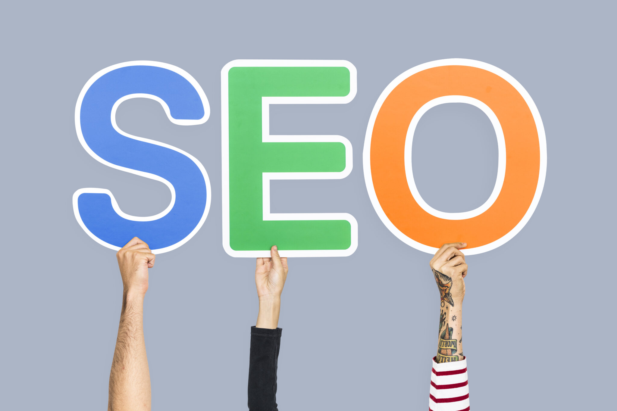 hands holding up colorful letters forming the abbreviation seo